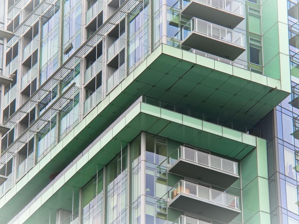 Free Image of Green contemporary building with glass balconies. 