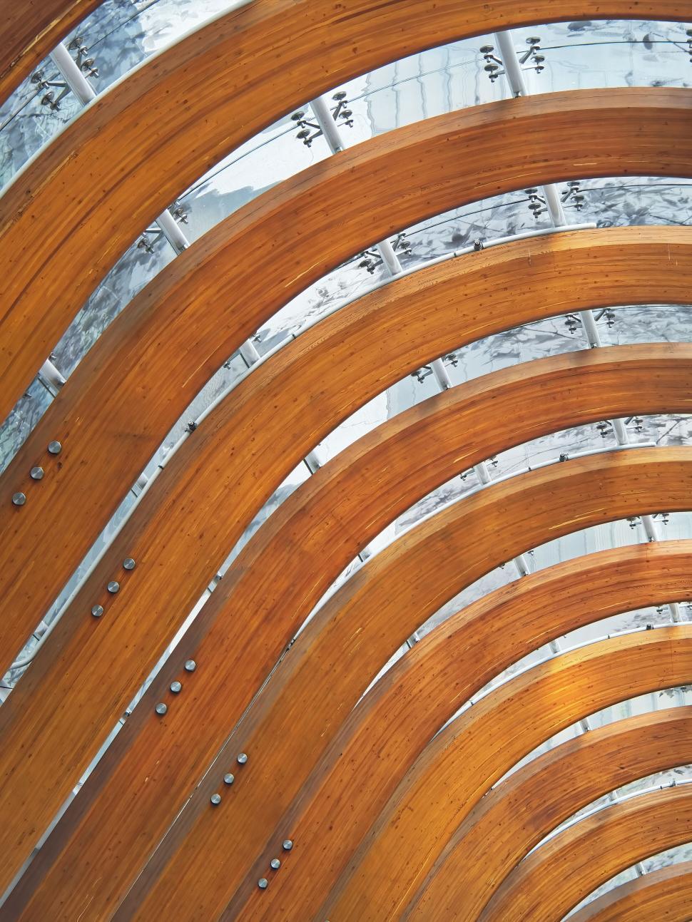 Free Image of Arched wooden beams in modern architectural design. 