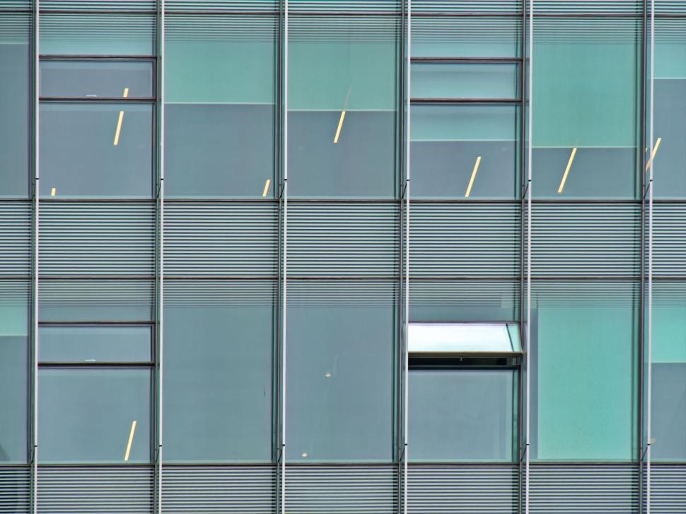 Free Image of Exterior of modern glass building with open window. 