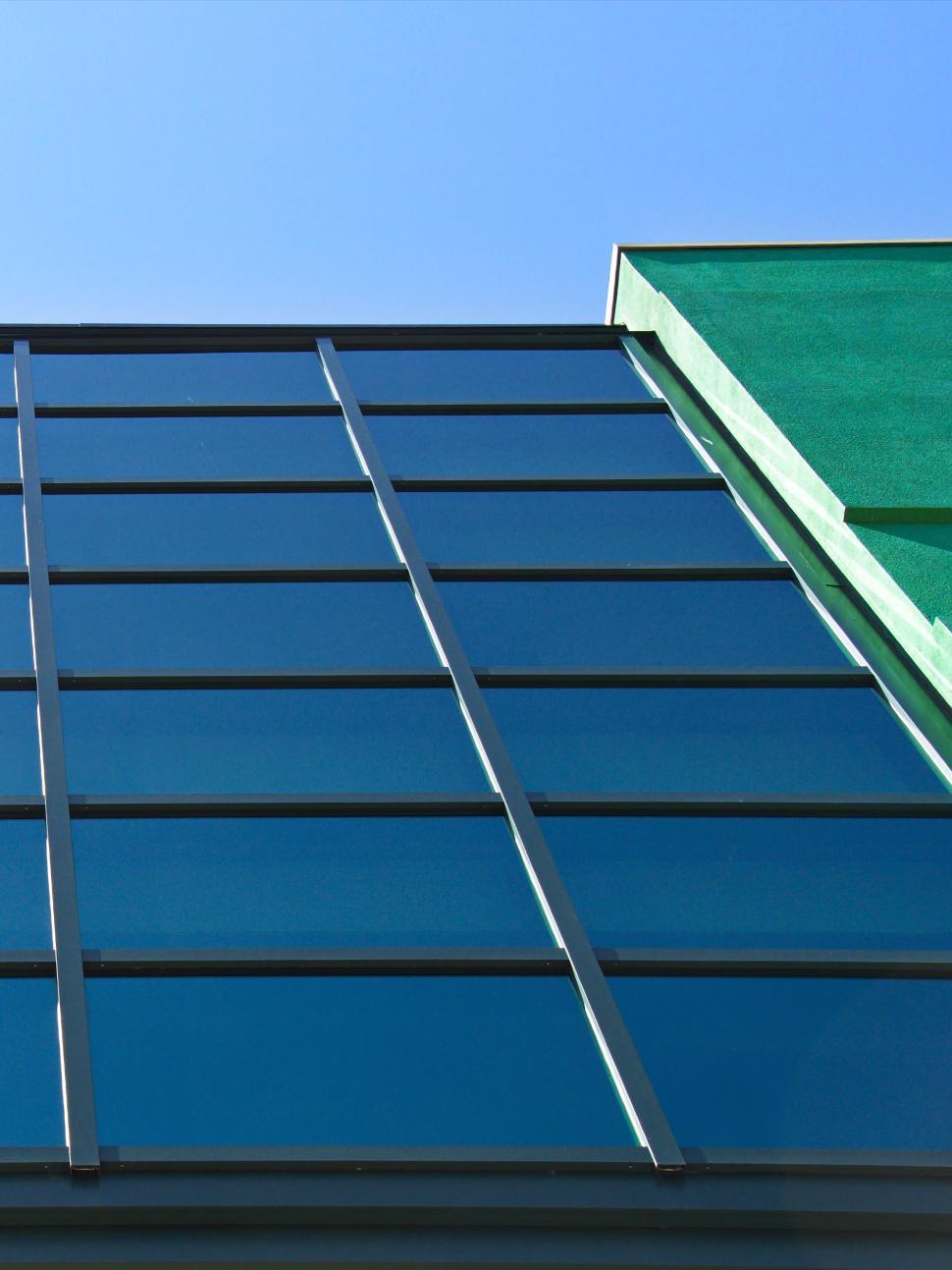 Free Image of Modern glass facade of office building against blue sky 