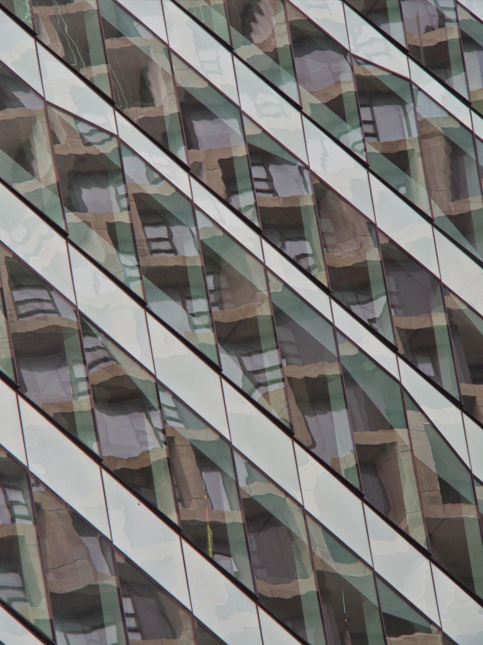 Free Image of Abstract reflections on glass building creating visual mosaic 