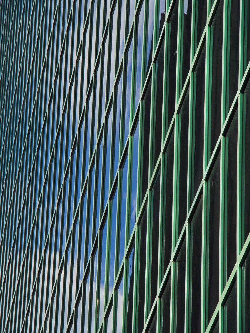 Free Image of Geometric glass and metal grid reflecting the sky 