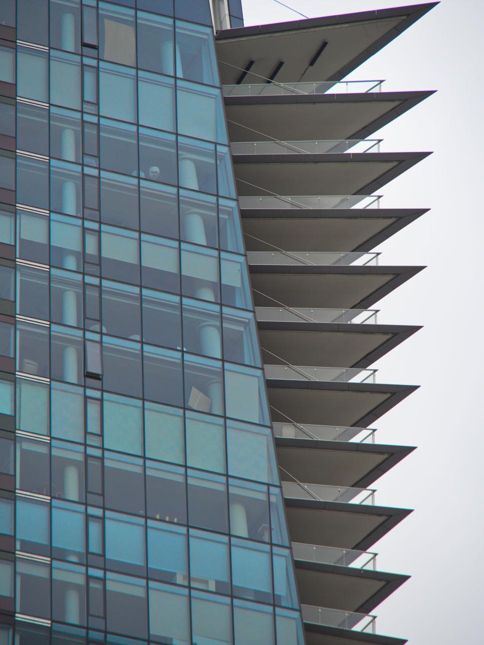 Free Image of Close-up of a building with glass windows and balconies 