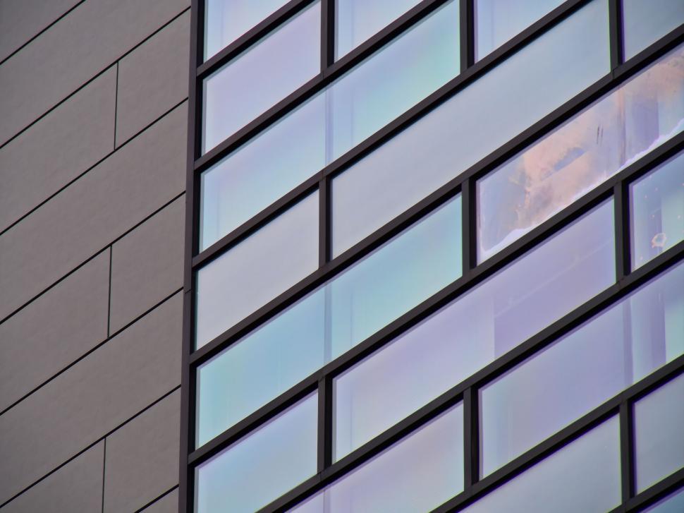 Free Image of Modern glass building with framed window reflections 