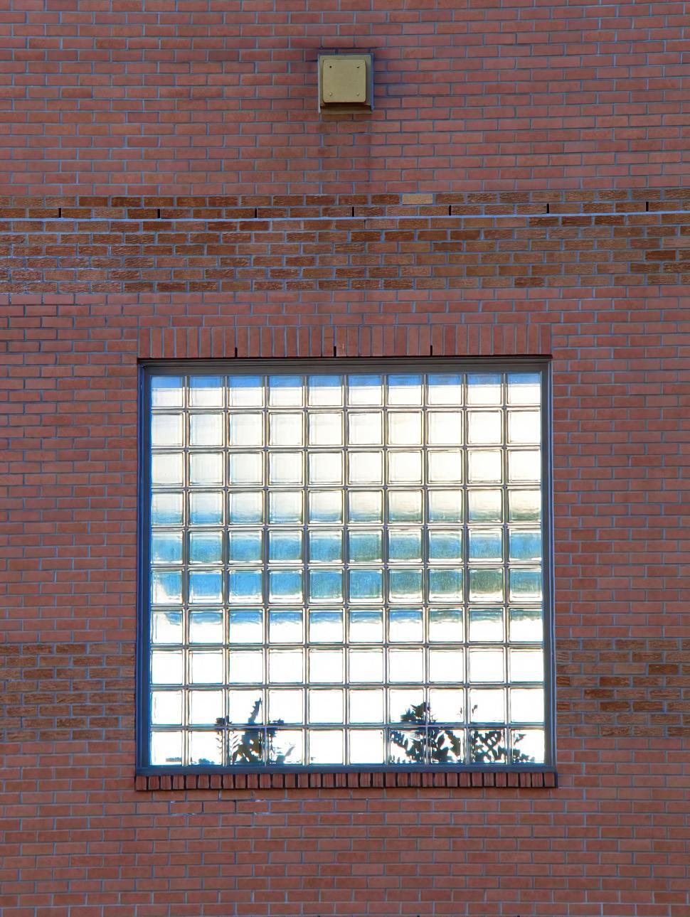 Free Image of Brick wall with square window composed of glass blocks 
