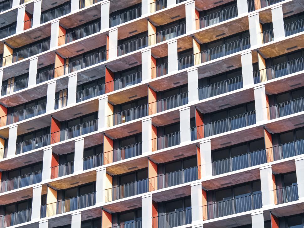 Free Image of Colorful apartment building grid with repetitive design. 