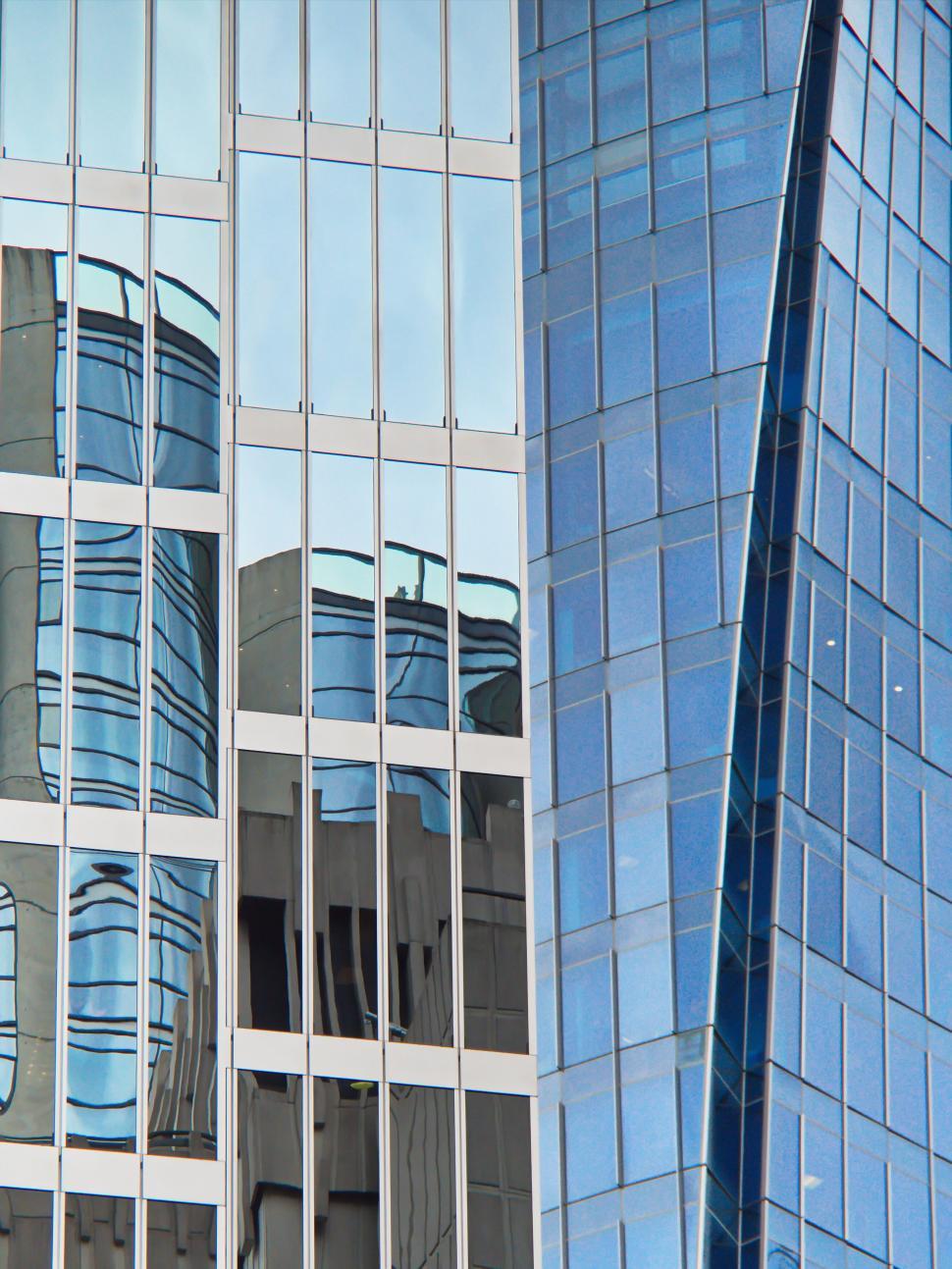 Free Image of Glass skyscraper reflections with modern architecture. 