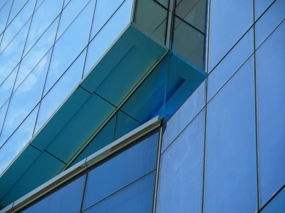 Free Image of Close-up of a modern glass building with extended windows 