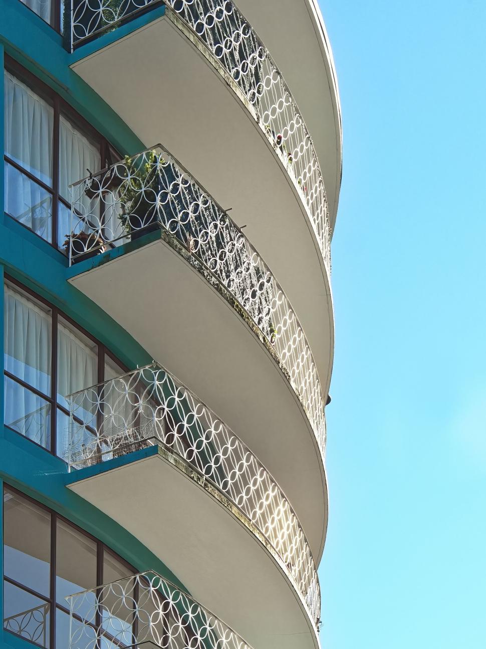 Free Image of Curved balconies with ornate railings, modern elegance 