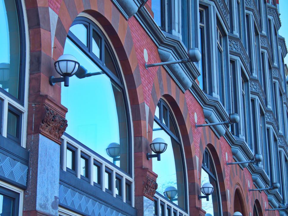 Free Image of Historic brick and stone building with arched windows. 