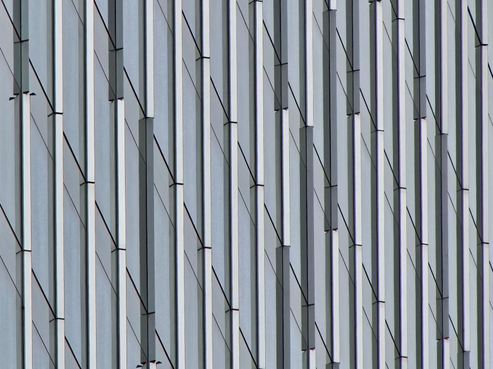 Free Image of Sleek vertical lines of a modern high-rise building facade. 