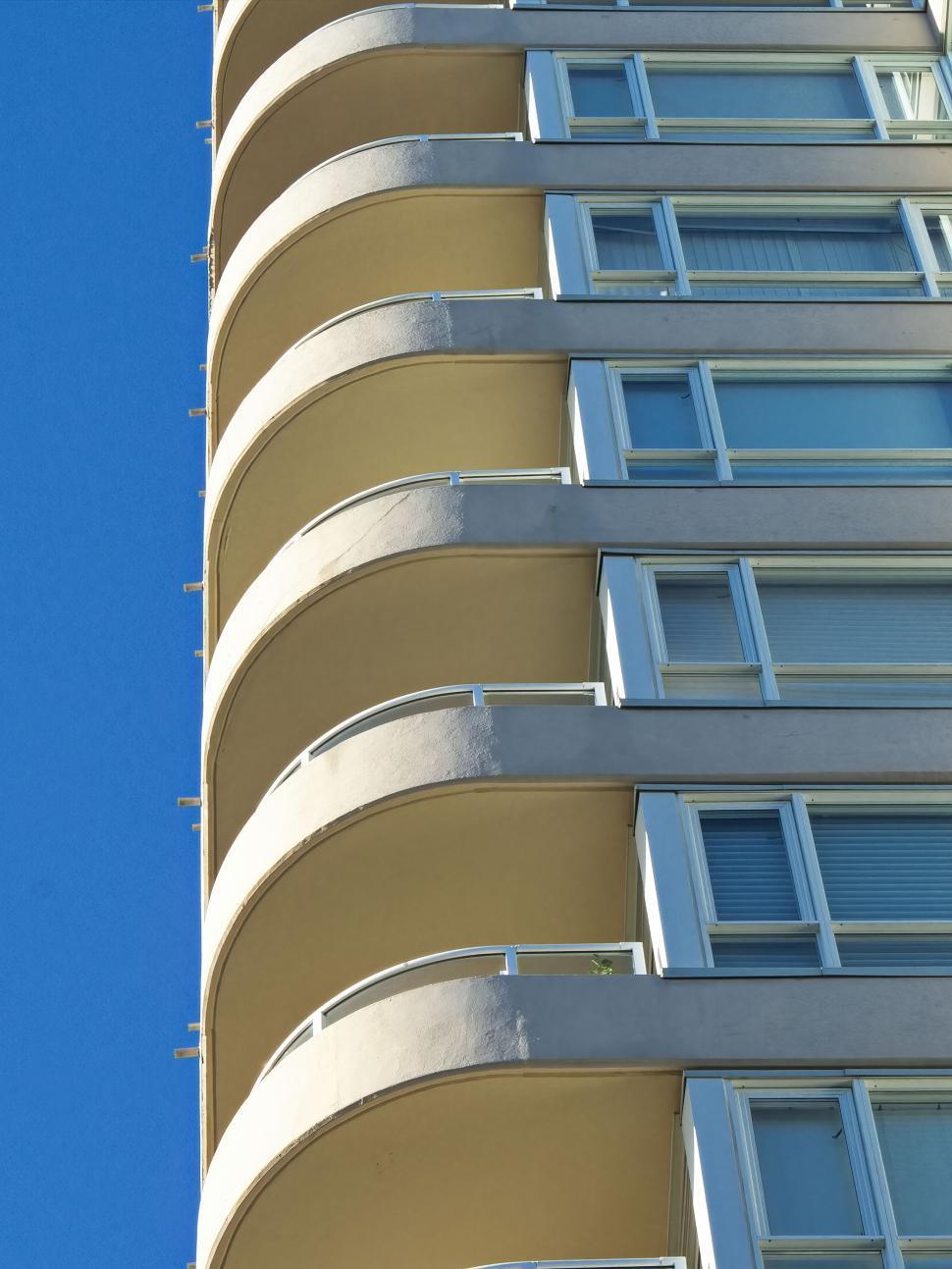 Free Image of Curved balconies against blue sky on modern building 