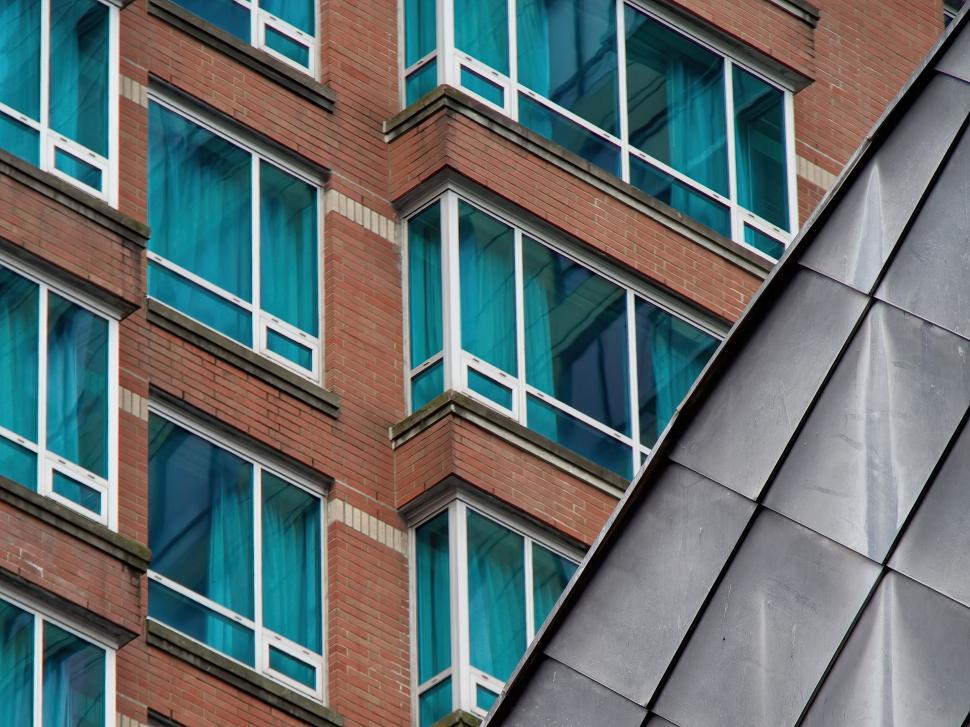Free Image of Brick and glass building corner with geometric metal 