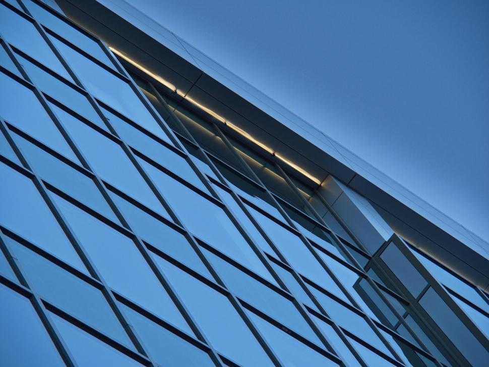 Free Image of Reflective blue glass facade of corporate office tower 