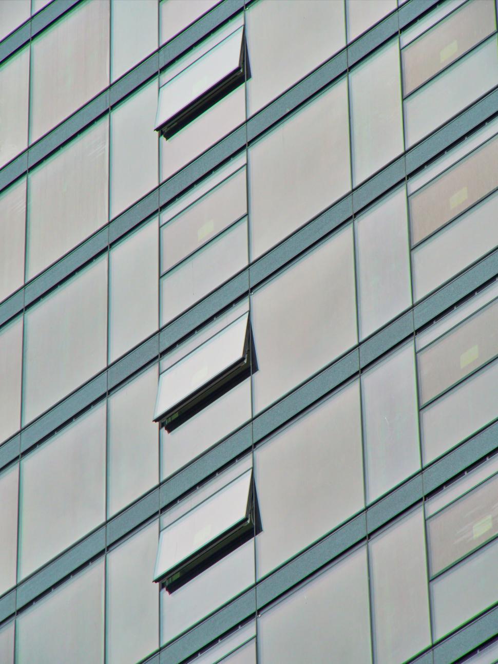 Free Image of Modern building facade with open windows, cityscape view 
