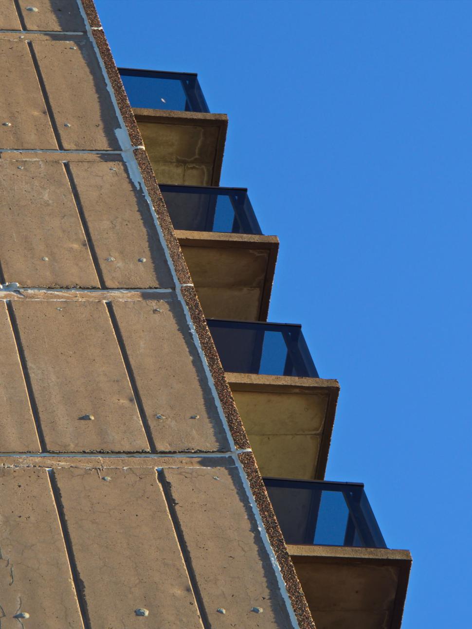 Free Image of Concrete staircases against blue sky in unique angles 