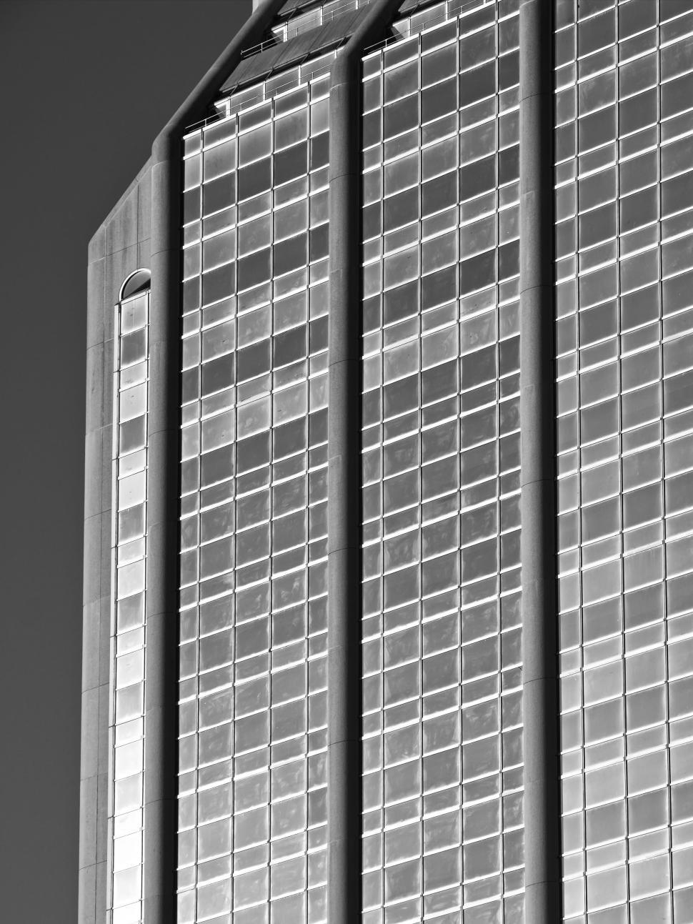 Free Image of Tall glass skyscraper reflecting light, urban perspective 