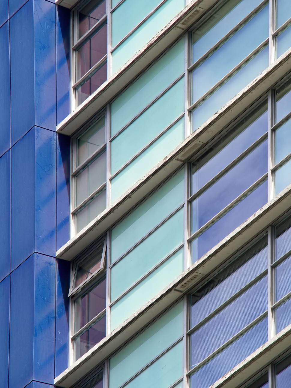 Free Image of Diagonal close-up of a modern glass building exterior 