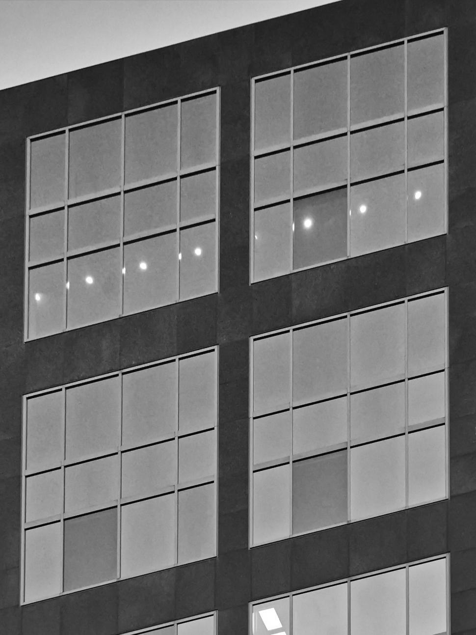 Free Image of Black and white image of building with large windows. 
