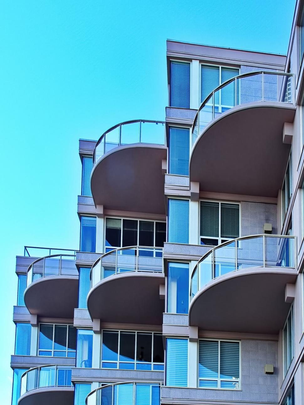 Free Image of Modern apartment building with curved balconies. 