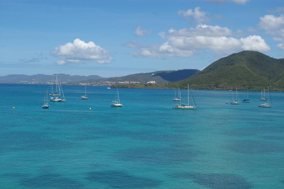 Free Image of Group of Boats Floating on Large Body of Water 