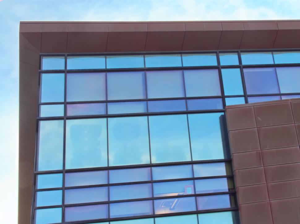 Free Image of Blue and grey glass windows of modern building structure 