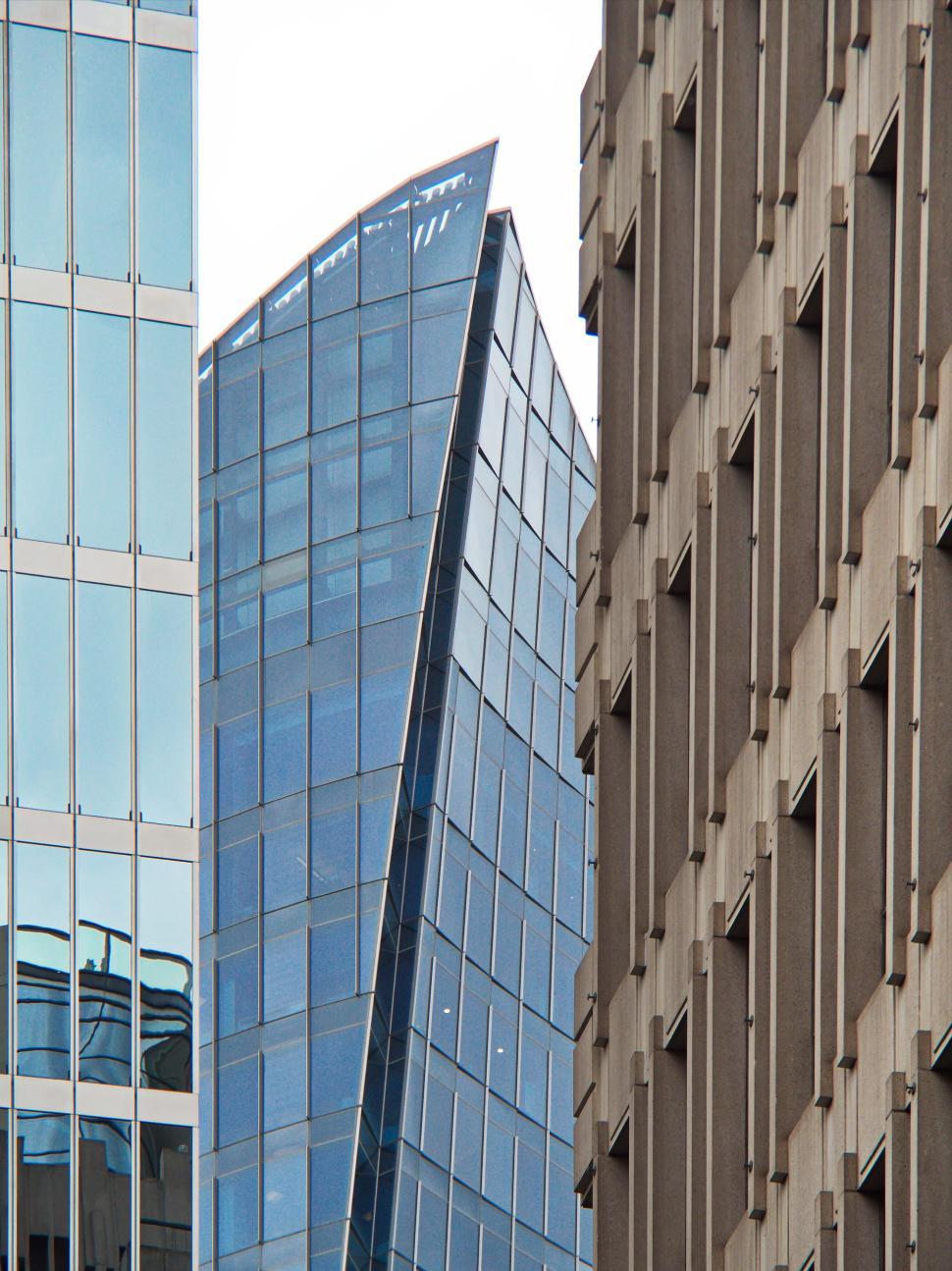 Free Image of Modern glass skyscraper with a unique curved design 