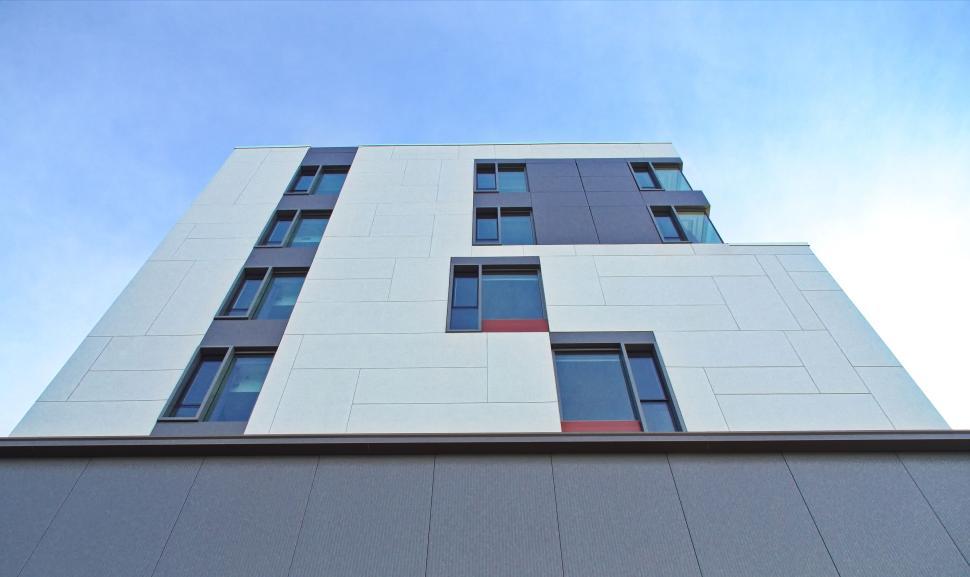 Free Image of Minimalistic white building with geometric window patterns 