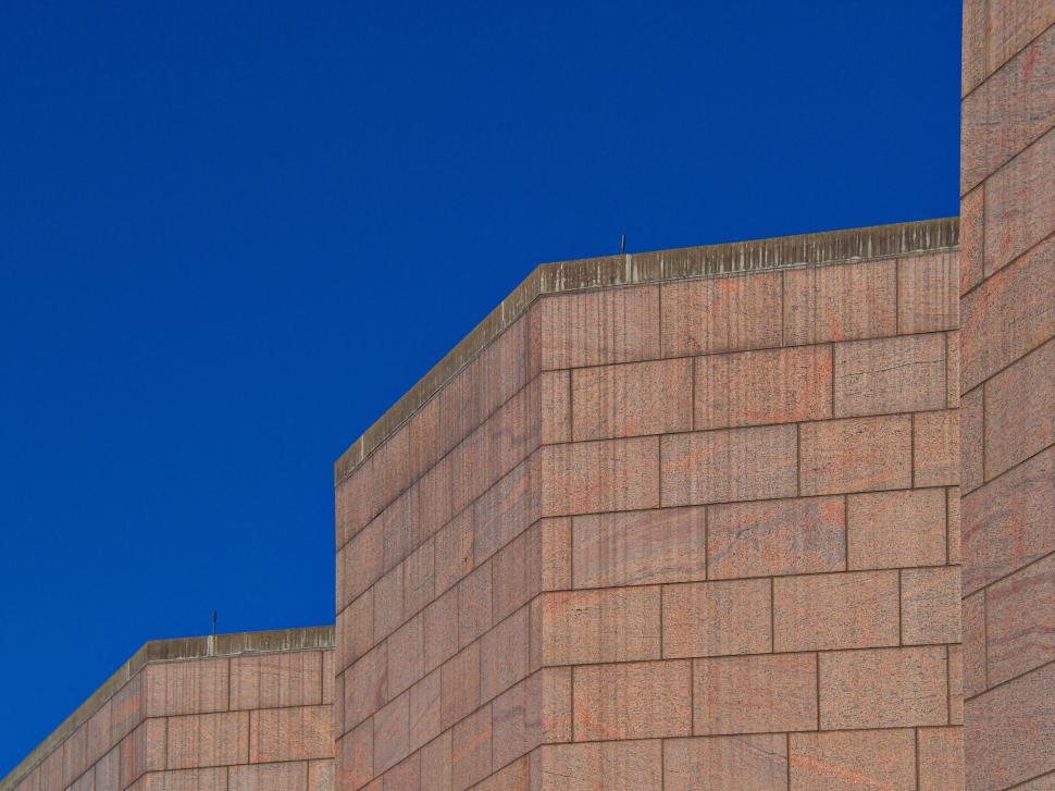 Free Image of Red-bricked building against clear blue cloudless sky 