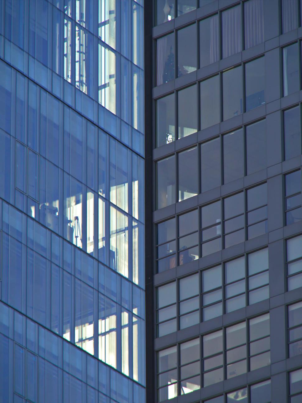Free Image of Modern glass skyscraper reflecting adjacent buildings 