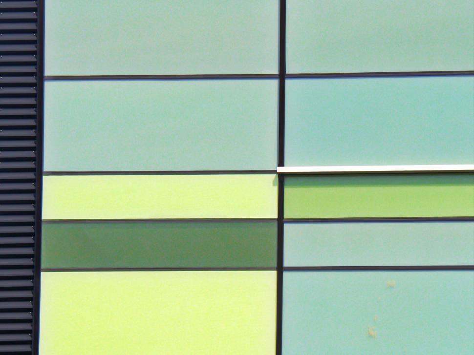 Free Image of Pastel-colored building facade with geometric patterns 