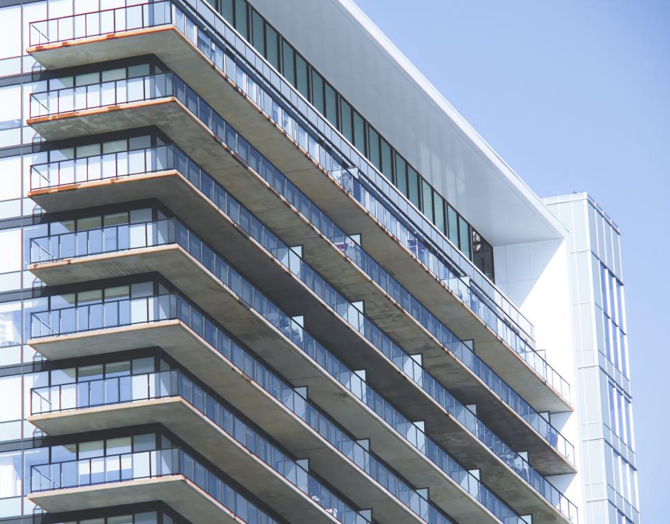 Free Image of Modern apartment building with balcony rows side view. 