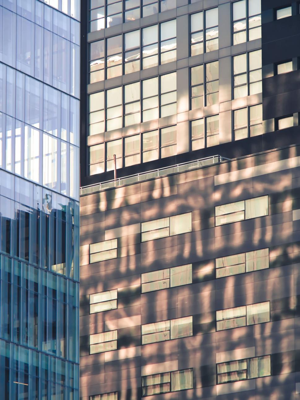 Free Image of Glass and shaded facade of modern buildings in sunlight. 