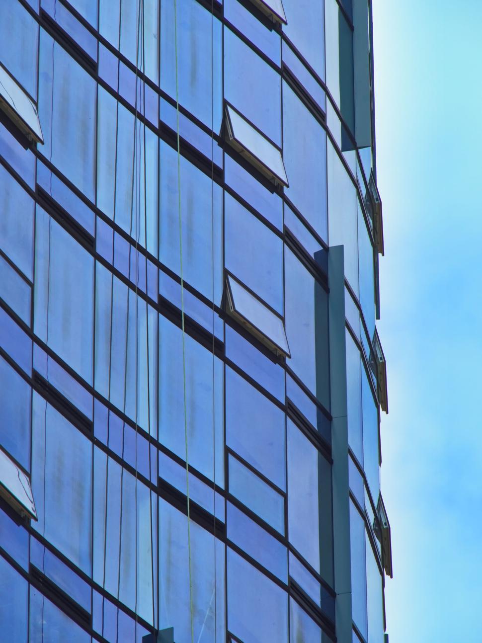 Free Image of Reflective glass skyscraper section with open windows 