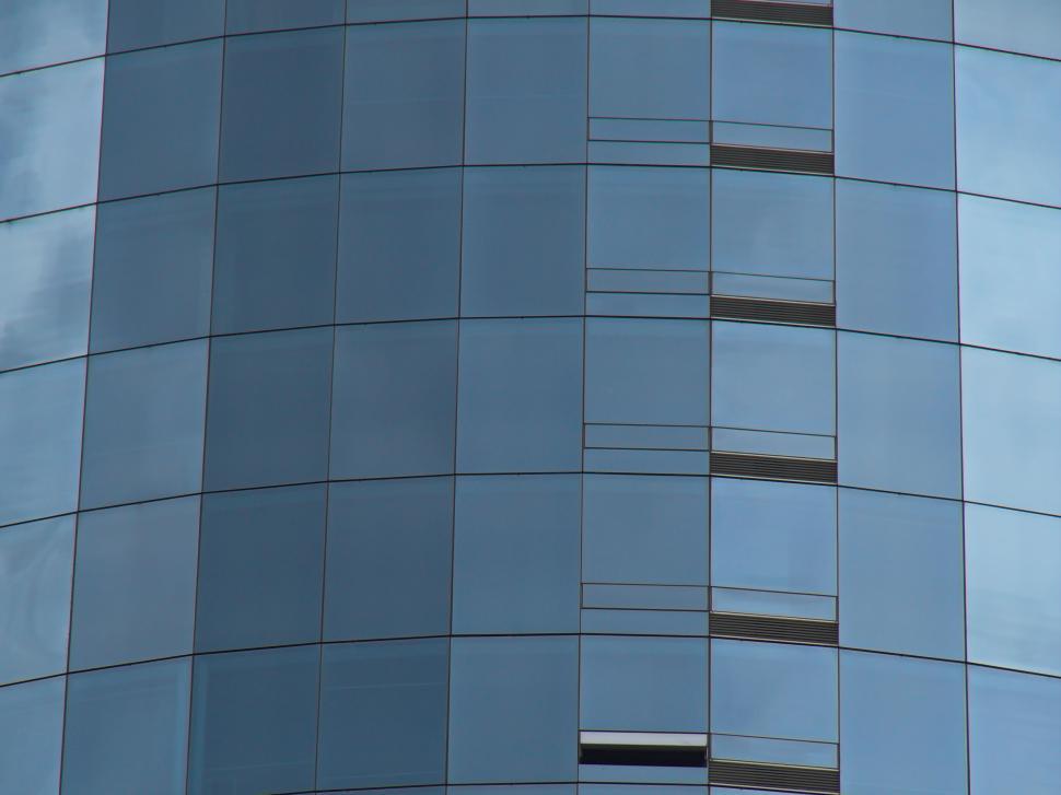 Free Image of Curved glass building facade with various window levels 