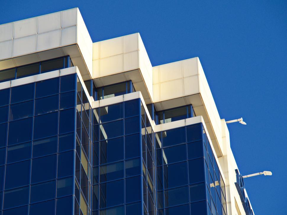 Free Image of Modern glass building with reflective surfaces and sky 