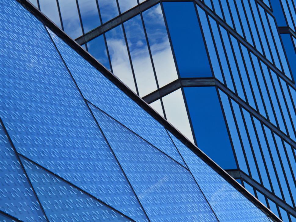 Free Image of Modern blue glass building with geometric reflections. 