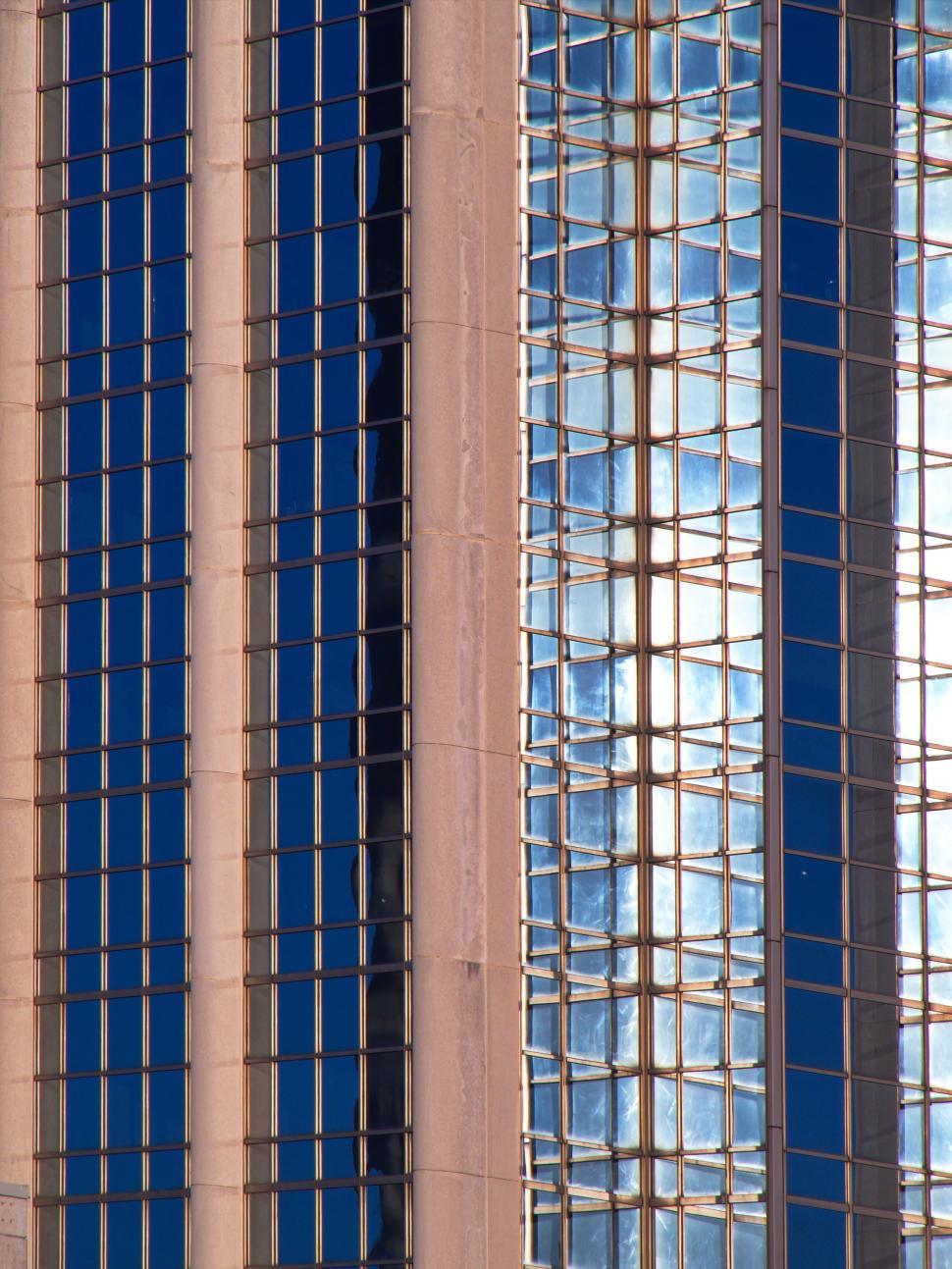 Free Image of Tall modern building with blue glass façade details. 