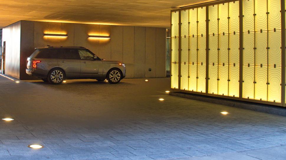 Free Image of Luxury car parked in an illuminated underground garage 
