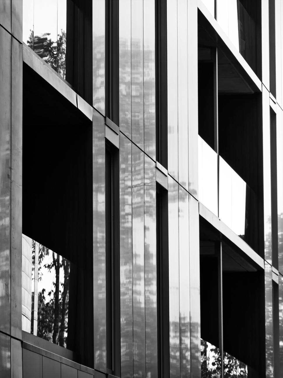 Free Image of Modern building with reflective glass windows in black-white 