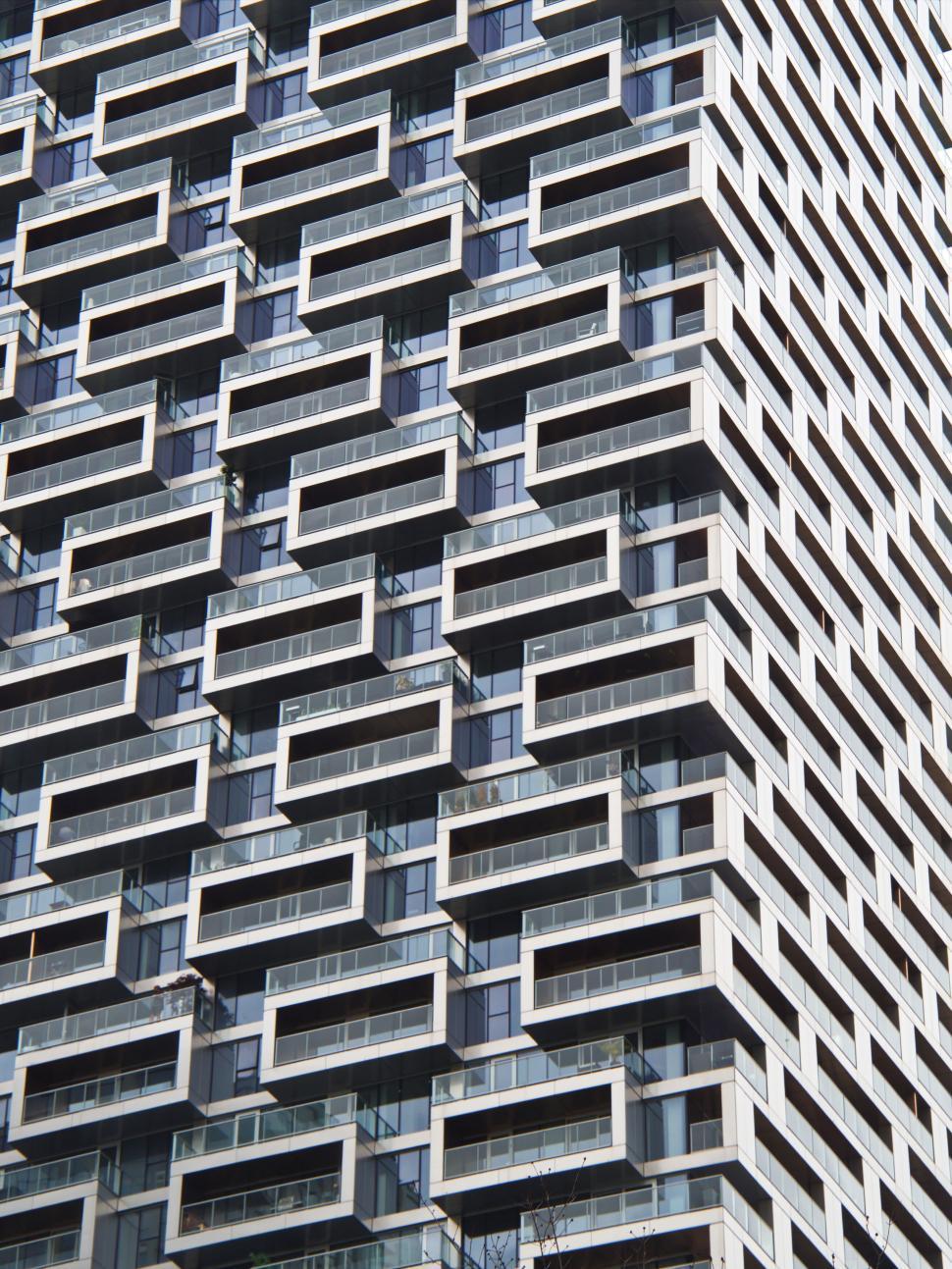 Free Image of Patterned high-rise building with irregular window design 