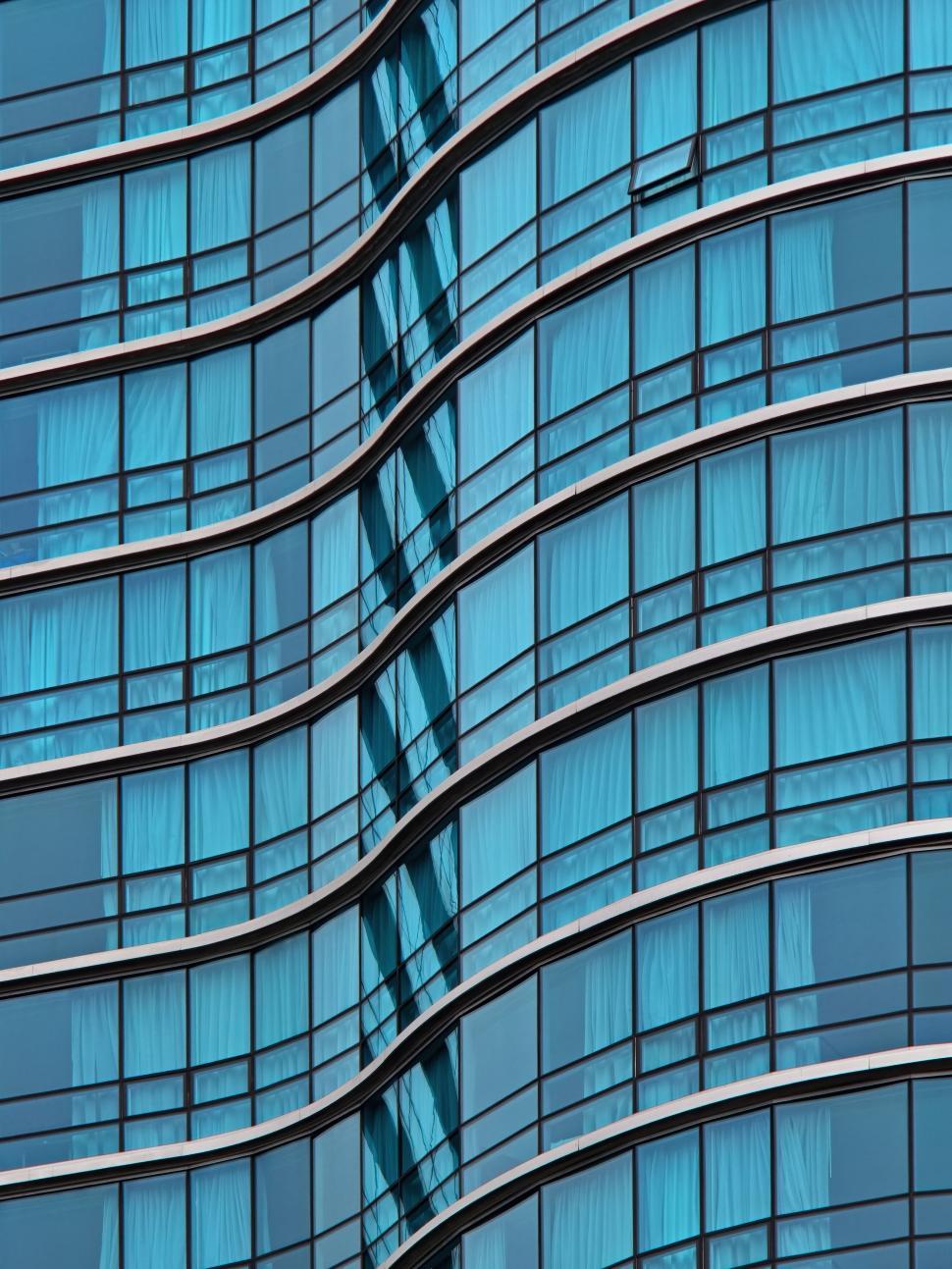 Free Image of Modern glass building exterior with blue reflections. 