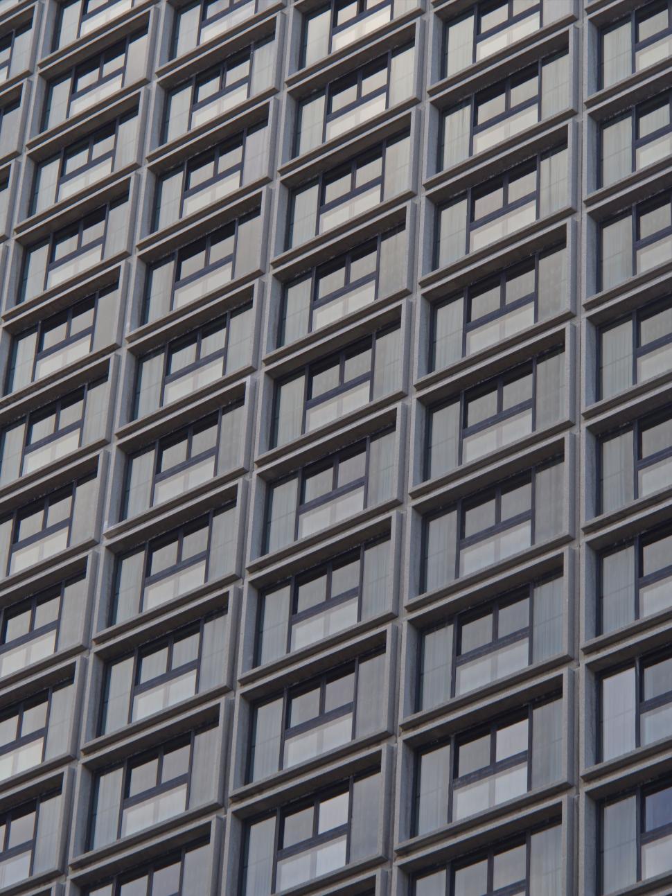 Free Image of Grid pattern windows on corporate urban skyscraper exterior. 