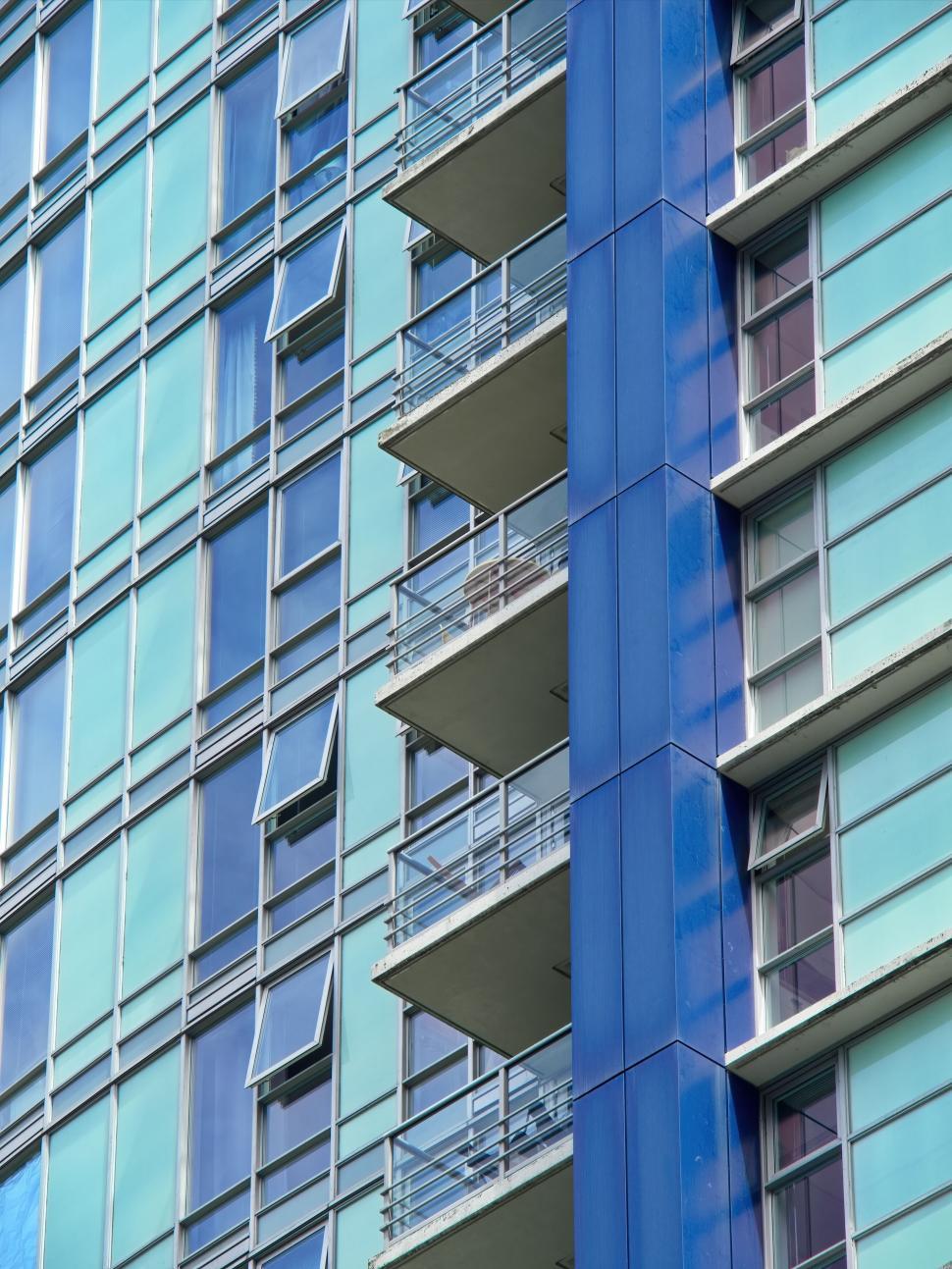 Free Image of Blue high-rise building exterior with balconies detail. 