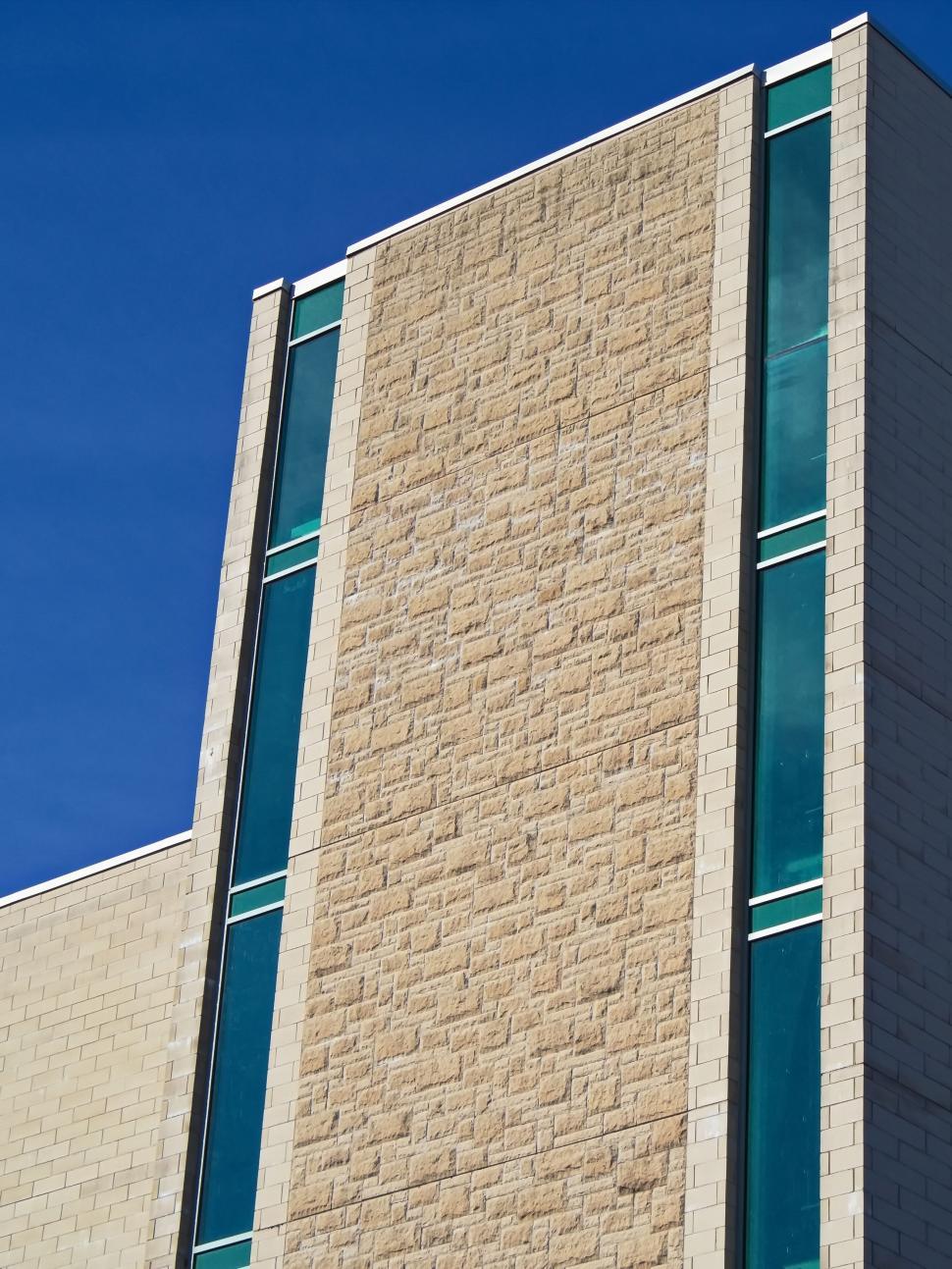 Free Image of Stone facade on modern building with vertical windows. 