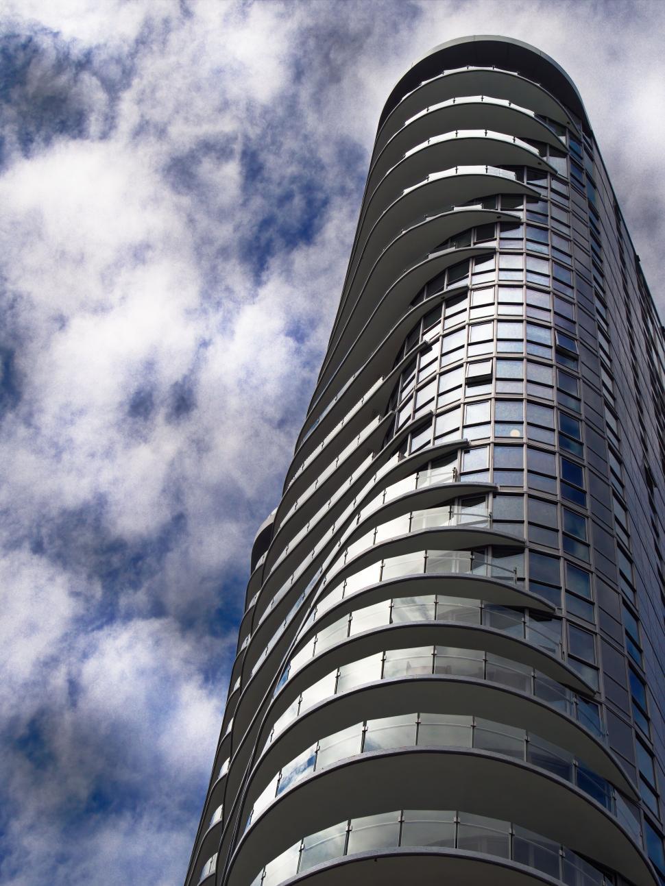 Free Image of Modern skyscraper with curved balconies reaching skyward 