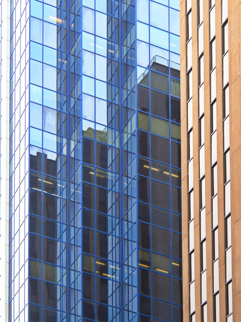 Free Image of Reflective glass facade of modern city high-rise building 