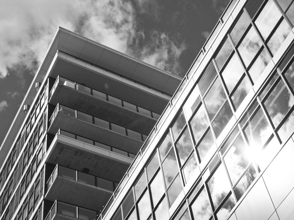 Free Image of Modern building with reflective glass and stacked balconies 