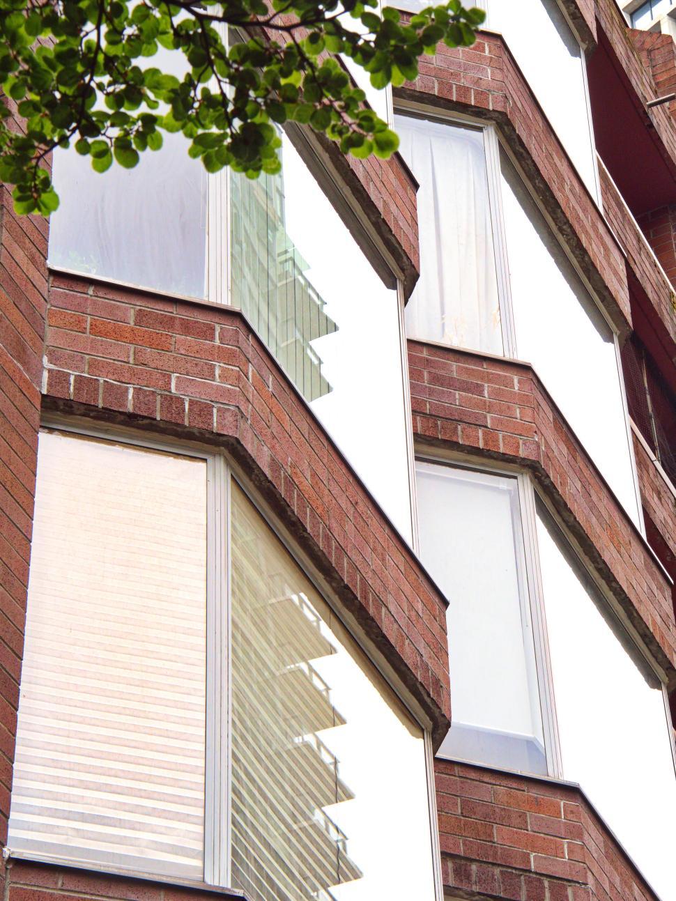 Free Image of Brick façade residential building with angled bay windows 
