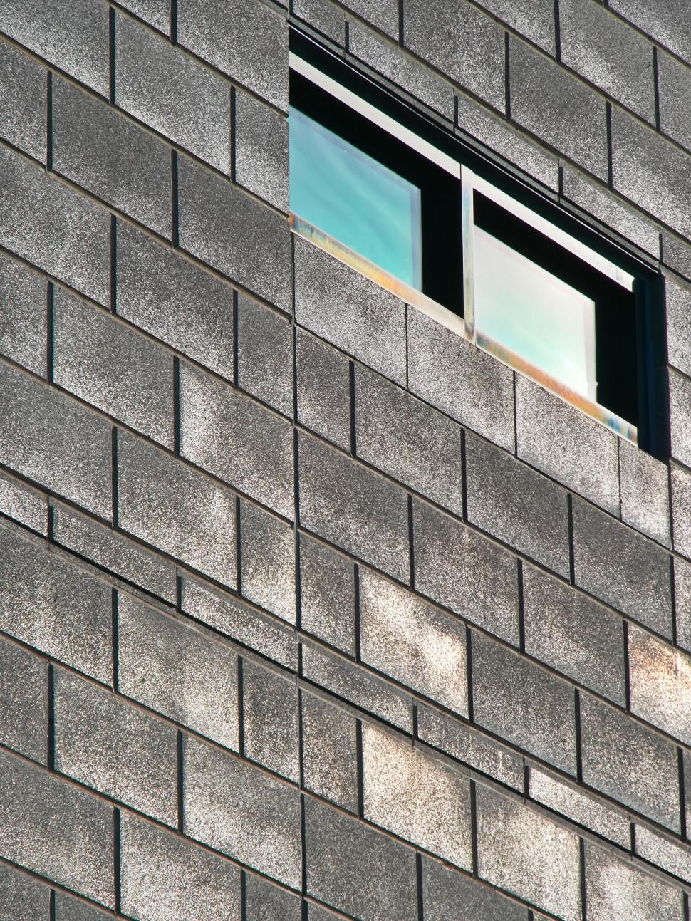 Free Image of Gray building with a single window and textured surface. 